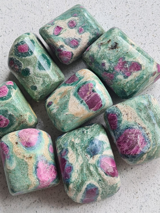 Ruby in Fuchsite Tumble stone from India. Green Fuchsite with Pinky Ruby for Passion and Spontineity. 
Photographes on a white granite background. 