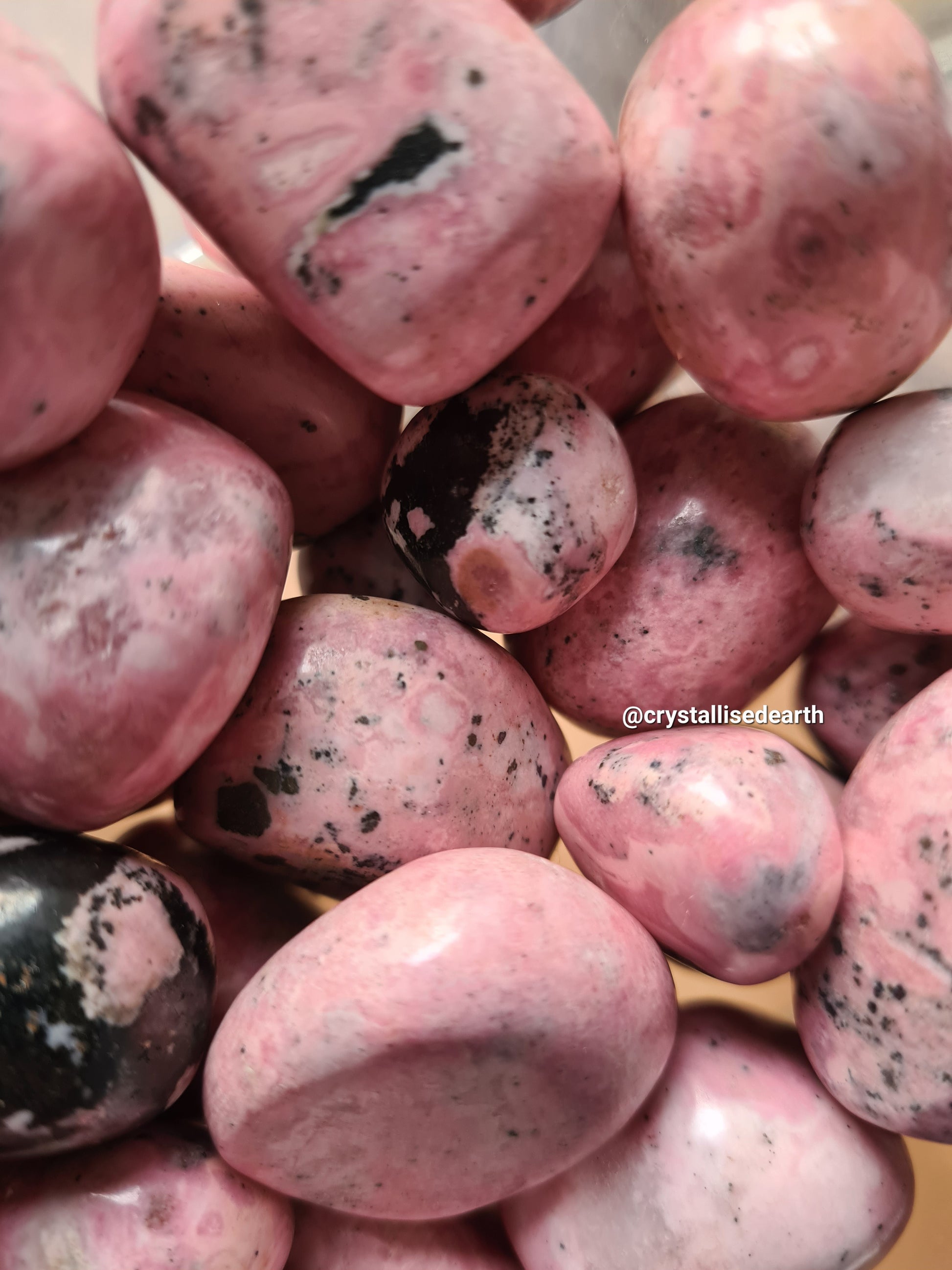 Pink Rhodonite Tumble stone from Peru, 3 sizes available. Each natural with black/white patches.
