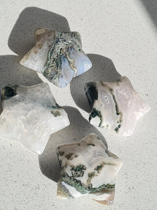 Collection of natural moss agate star carvings. Each with green moss inclusions, with white chalcedony and clear quartz.