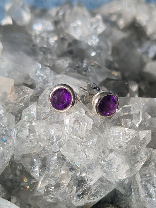 A pair of faceted round Amethyst set stud earrings in sterling silver