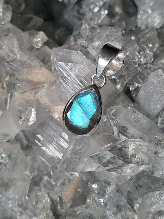 A Pendant with a faceted teardrop shaped labradorite with bright blue flash set into sterling silver.