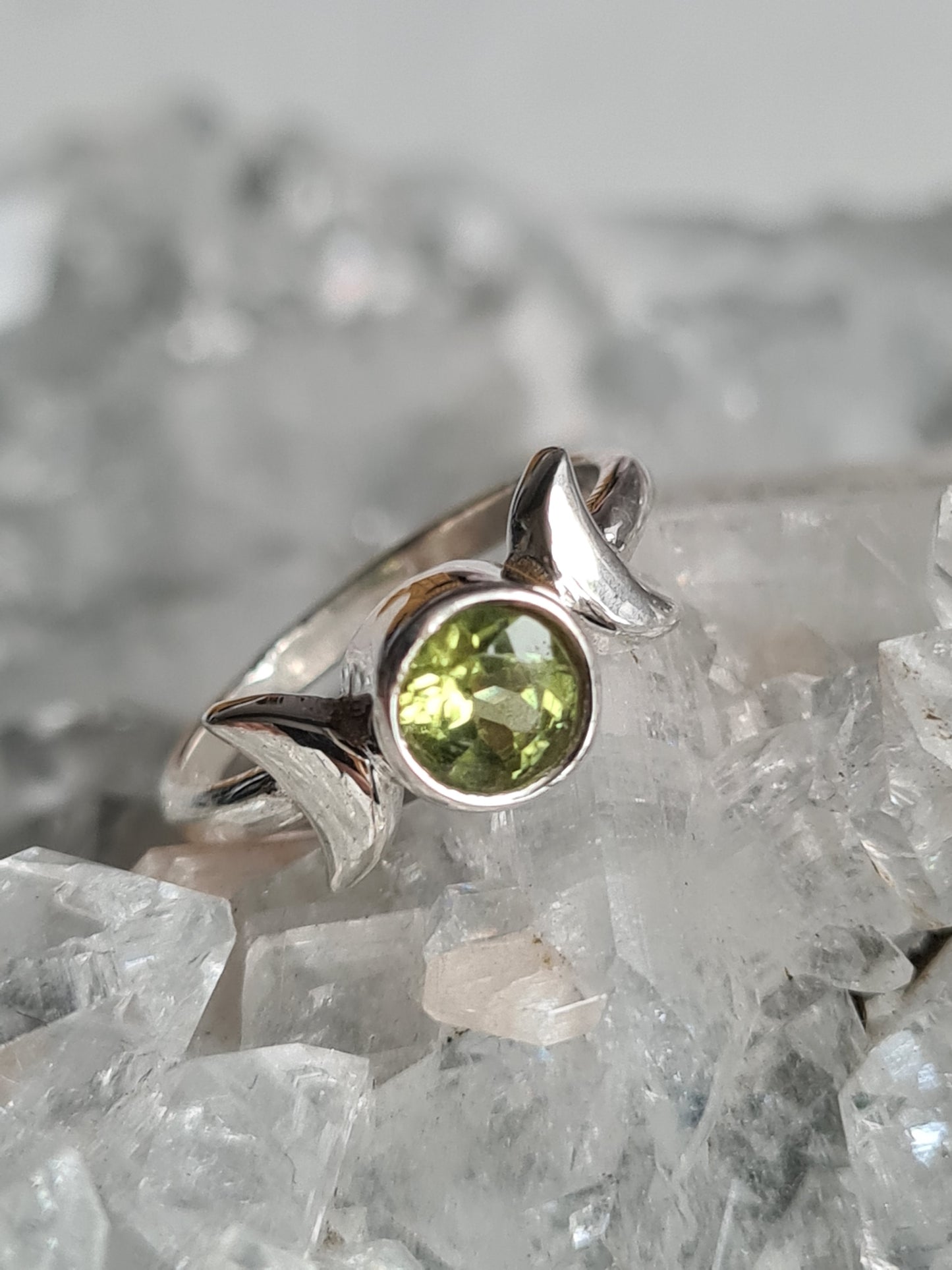 Triple Moon Ring set with a round faceted peridot gemstone