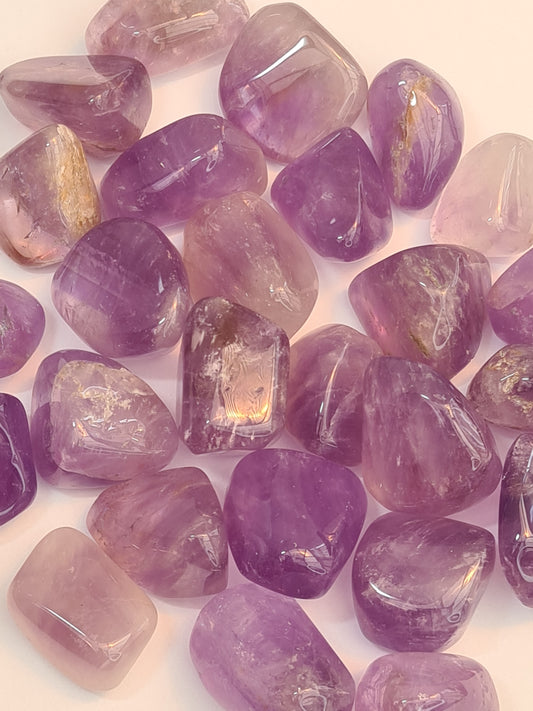 Purple Amethyst Tumbles from Bolivia, naturally coloured with banding of clear quartz in some pieces. 2 sizes available.
Photographed in natural sunlight on a white background. 