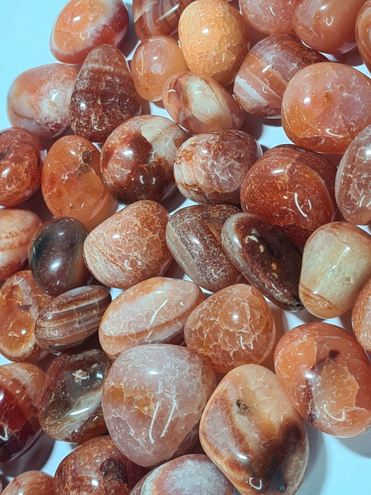 Vivid orange banded carnelian tumble stone from India
