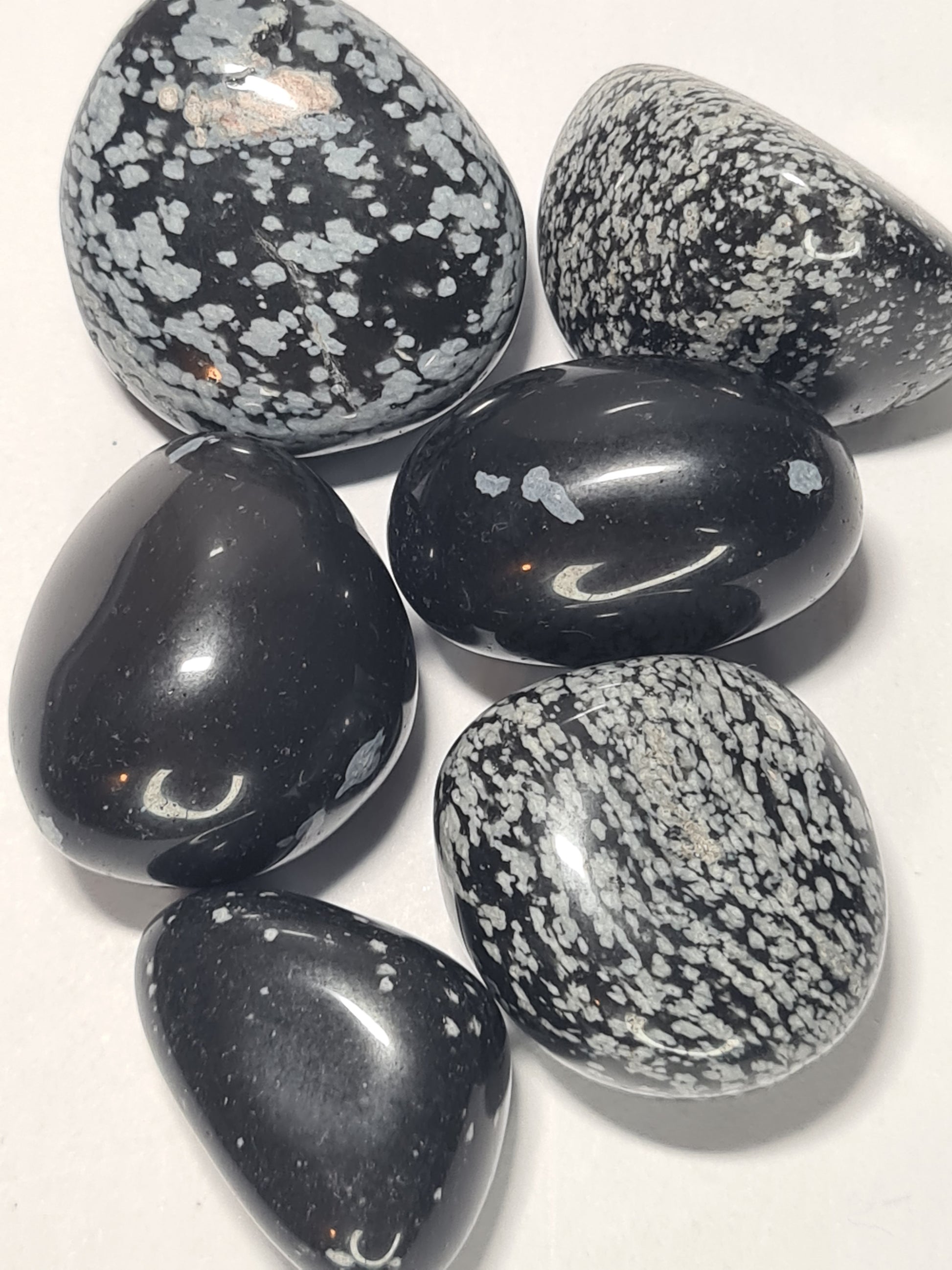 Natural Snowflake Obsidian Tumbles, containing white chrysobalite inclusions giving the look of snowflakes in the tumbles