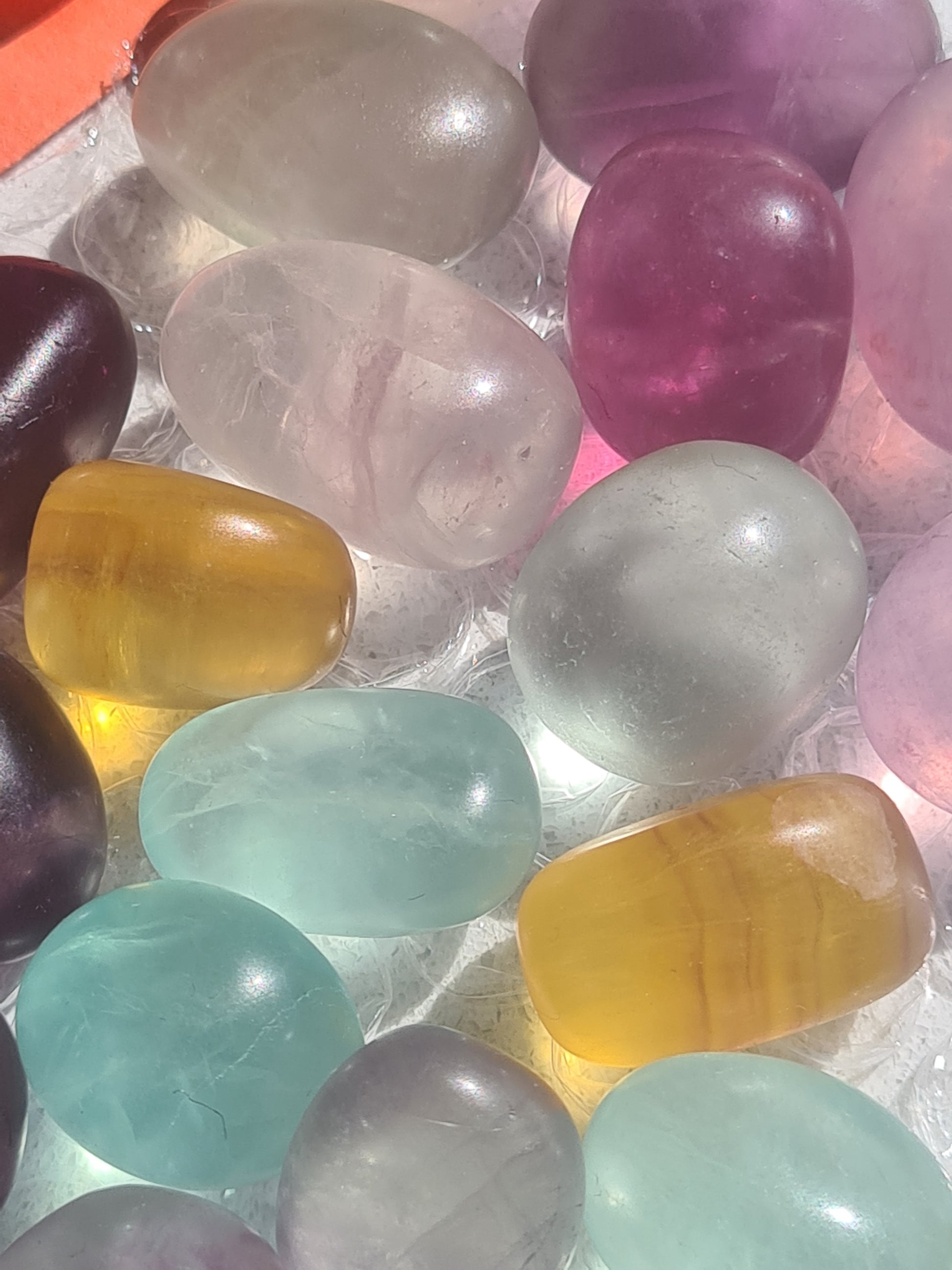 Vivid Candy Coloured Fluorite Tumbles, shown in yellow, white, purple and blue. 3 sizes available. 