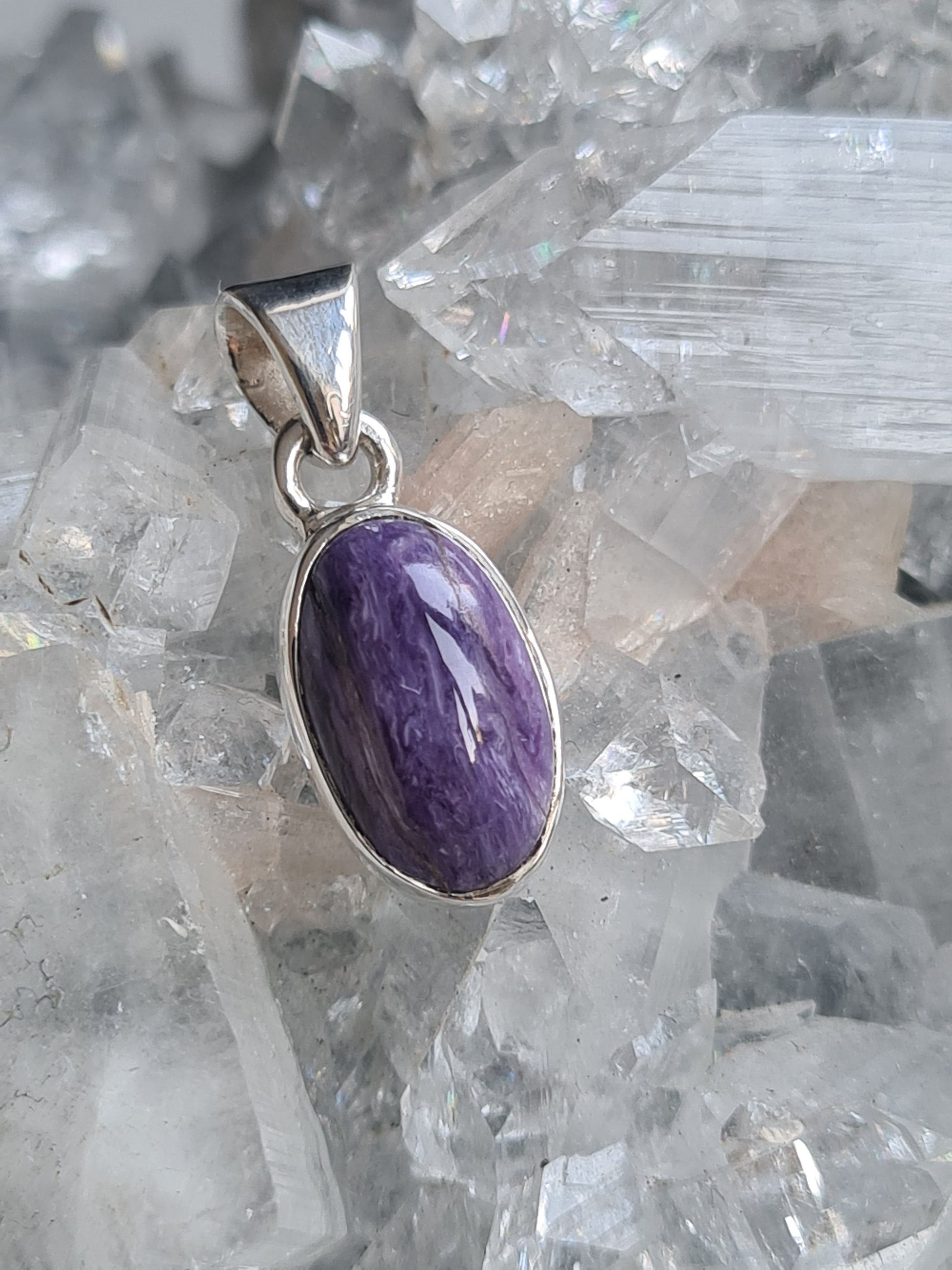 Natural Russian Purple Charoite Pendant in Sterling Silver. Oval shape.
Photographed on a diamond apophyllite cluster.