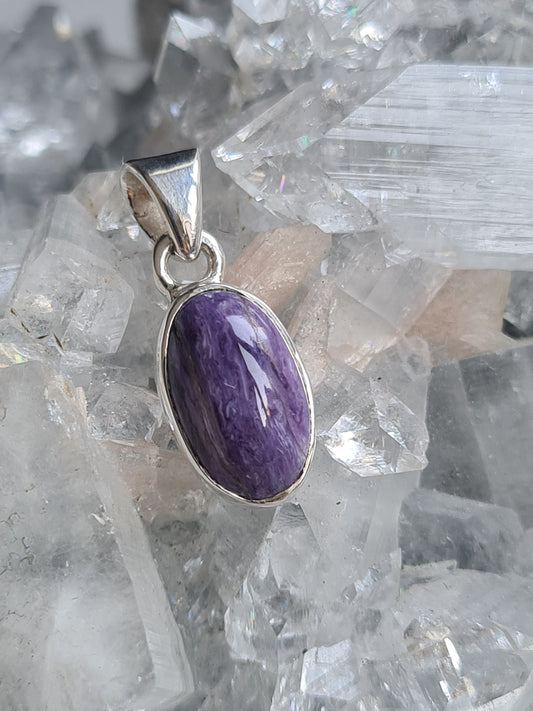 Natural Russian Purple Charoite Pendant in Sterling Silver. Oval shape.
Photographed on a diamond apophyllite cluster.