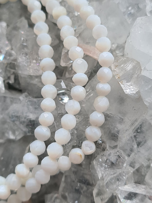 3mm faceted bead white mother of pearl bracelets, on crystallised background.
