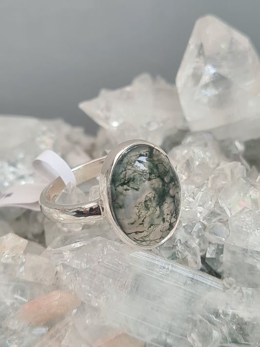 Natural Moss agate set ring in sterling silver. Oval shaped cabochon, rubover set, D-shaped shoulders/shank. UK Size P and half.