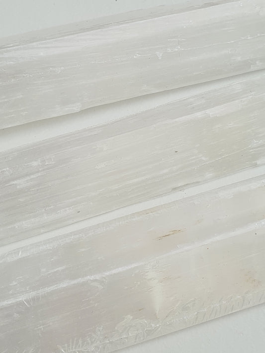 Close up of our Natural Raw Satin Spar Selenite Batons, measuring between 40cm and 45cm in length.