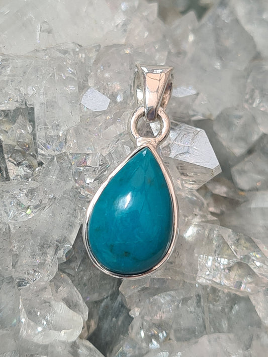 A pear shaped Vivid Turquoise set pendant in Sterling silver. 
Photographed on a natural apophyllite crystal. 
