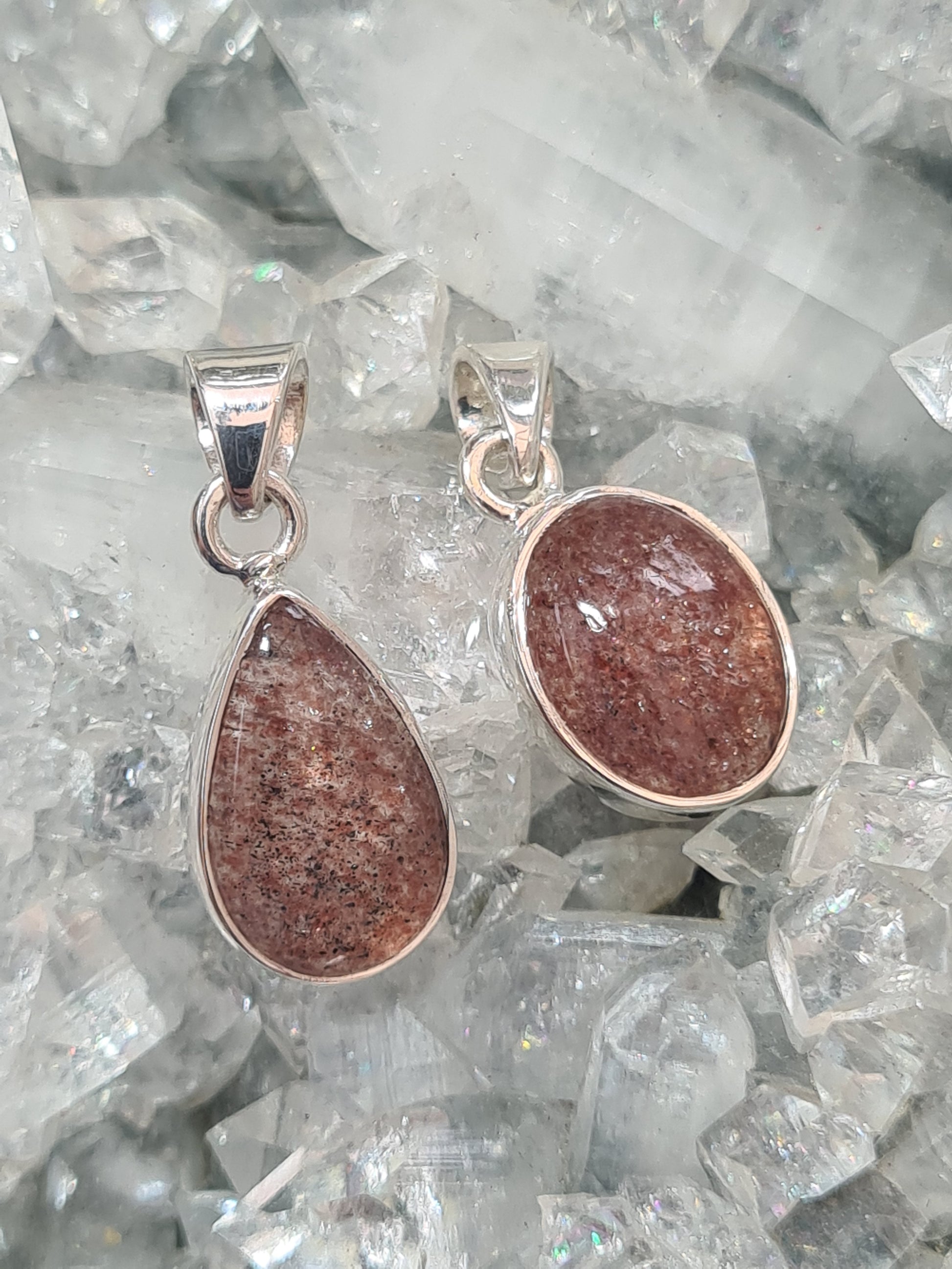 Two Strawberry Quartz Set Pendants in Sterling Silver. 1 pear shaped and 1 oval shaped.