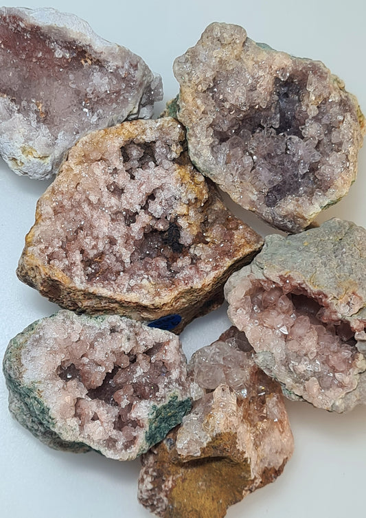 Collection of small Pink Amethyst half geodes, full of sparkling points and druzy. Raw backed.
Six pieces photographed on a white background. 