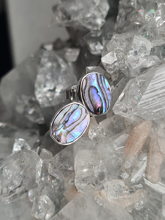 Natural Abalone Shell Stud Earrings in sterling silver. Featuring a blue/purple oval abalone in a bezel setting for pierced ears.