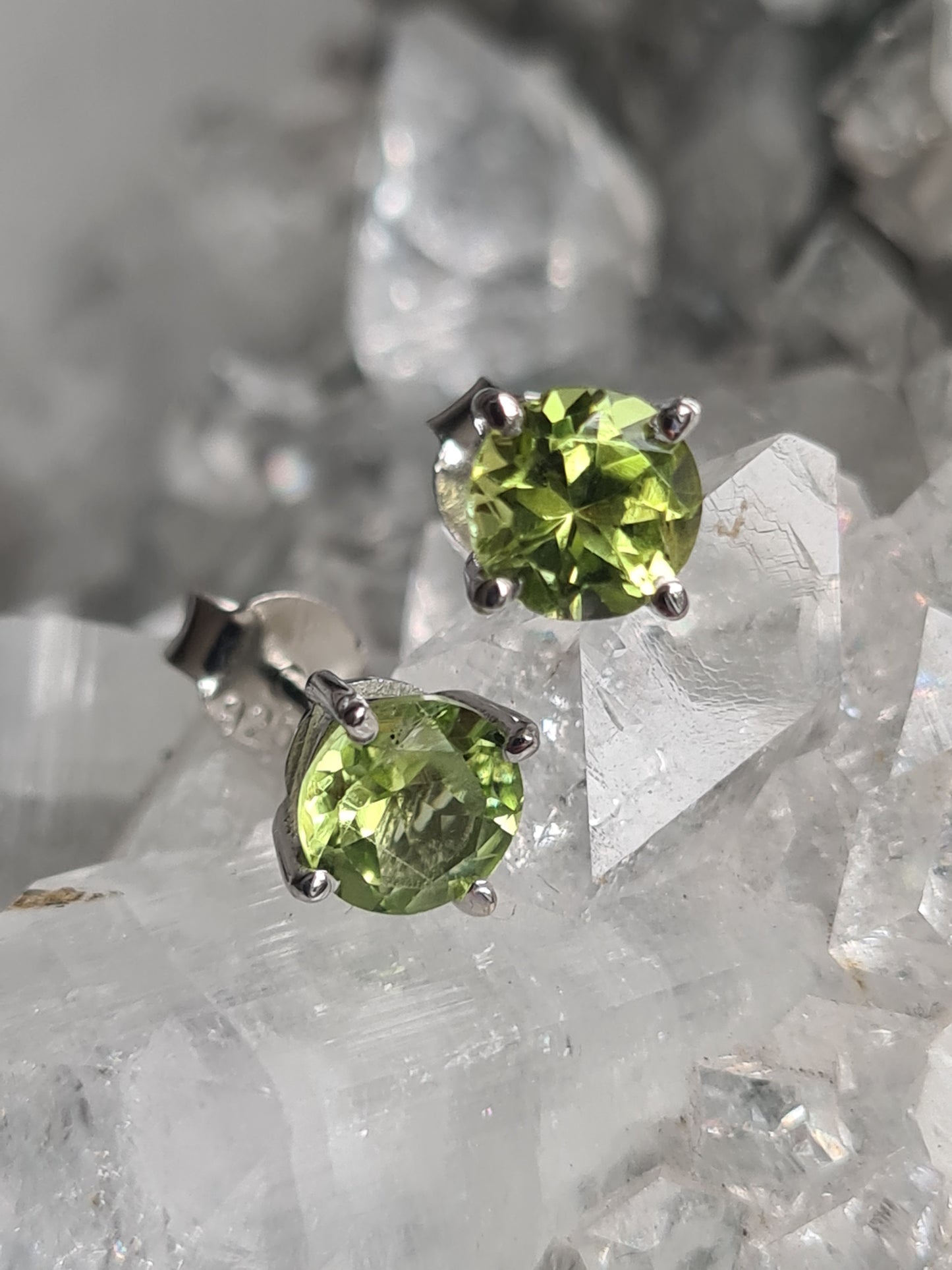 Natural green peridot set stud earrings with a round faceted Peridot. Sterling silver.