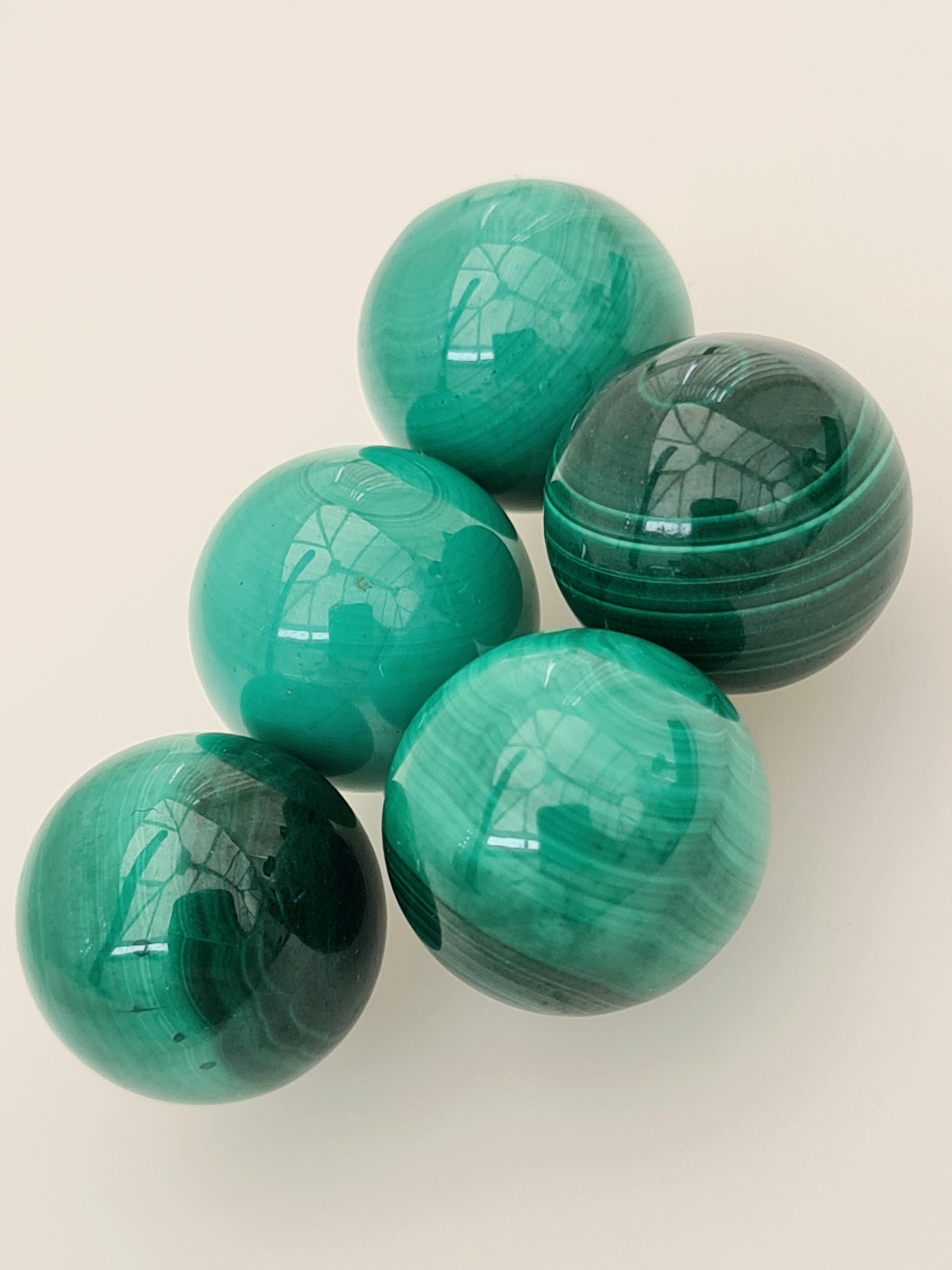 Mini malachite spheres in different tones of green with natural banding. 11mm diameter size.