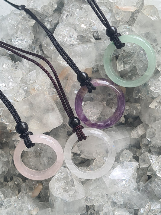 Natural Crystal Doughnut Necklaces in Rose Quartz , Clear Quartz, Amethyst and Aventurine. On cord fabric necklace. Adjustable. 