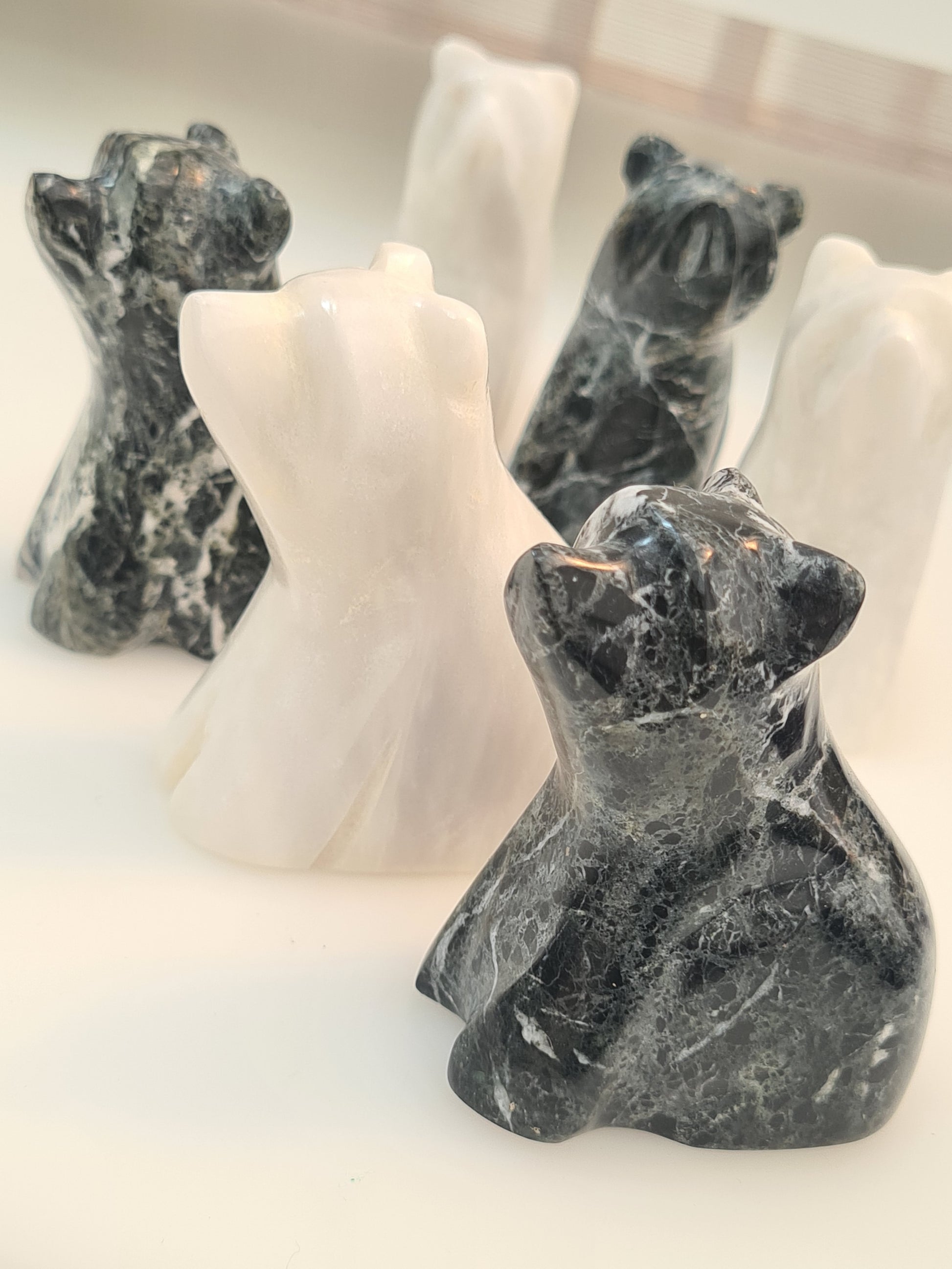 White and Black Onyx Bear Carvings, with banding and multi tonal colour. 3 inch height. On white background. 