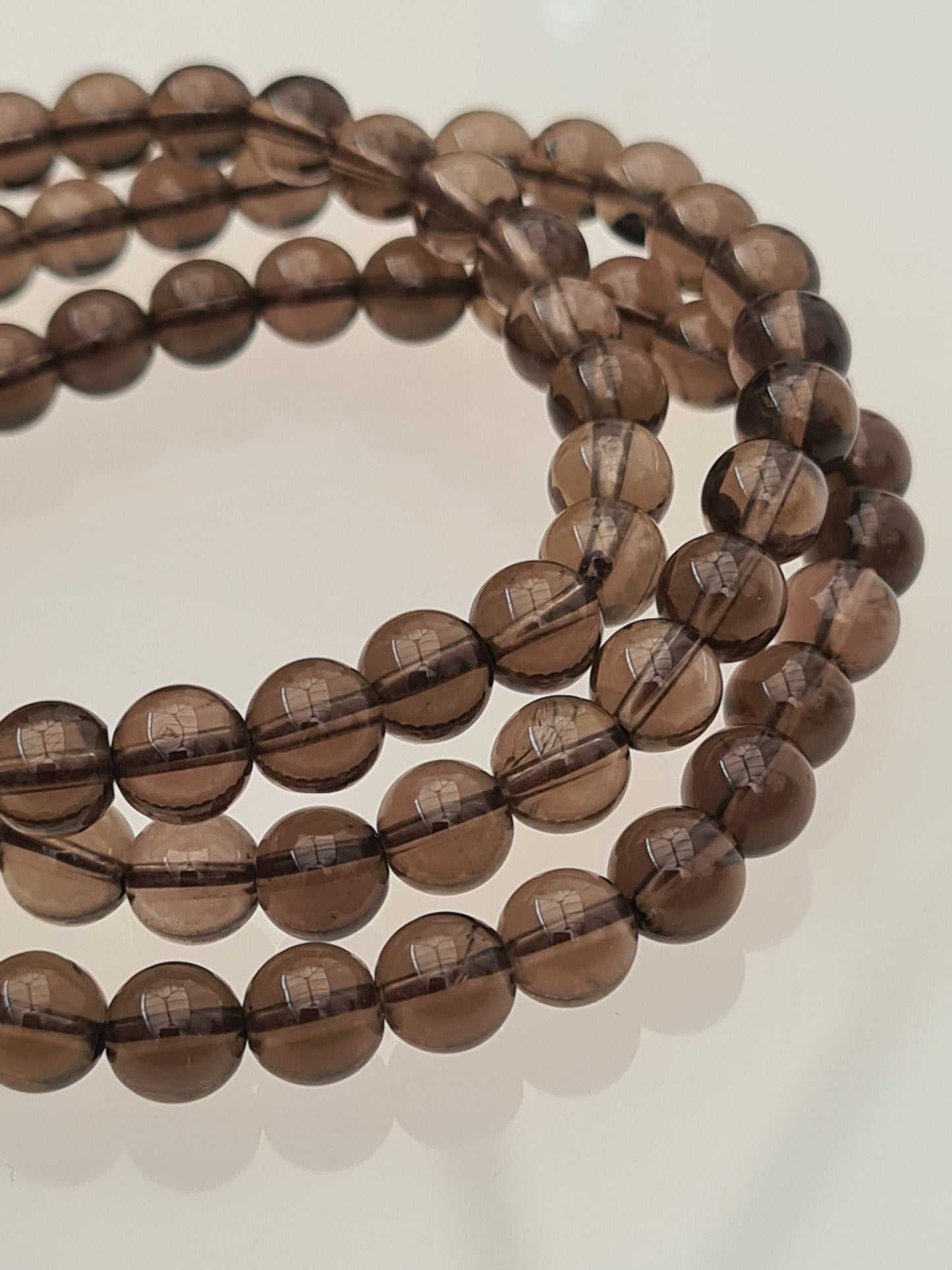 Three Rich Brown Smoky Quartz 6mm Beaded Bracelets, photographed on a white background. 