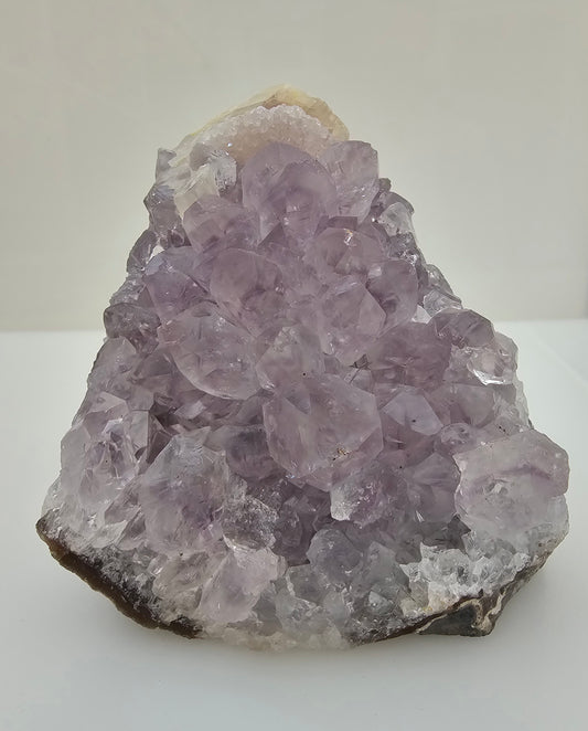 Natural Brazilian Amethyst Cluster Freeform. Sugar druzy calcite to the top. 1.09kg. Photographed on a white background. 