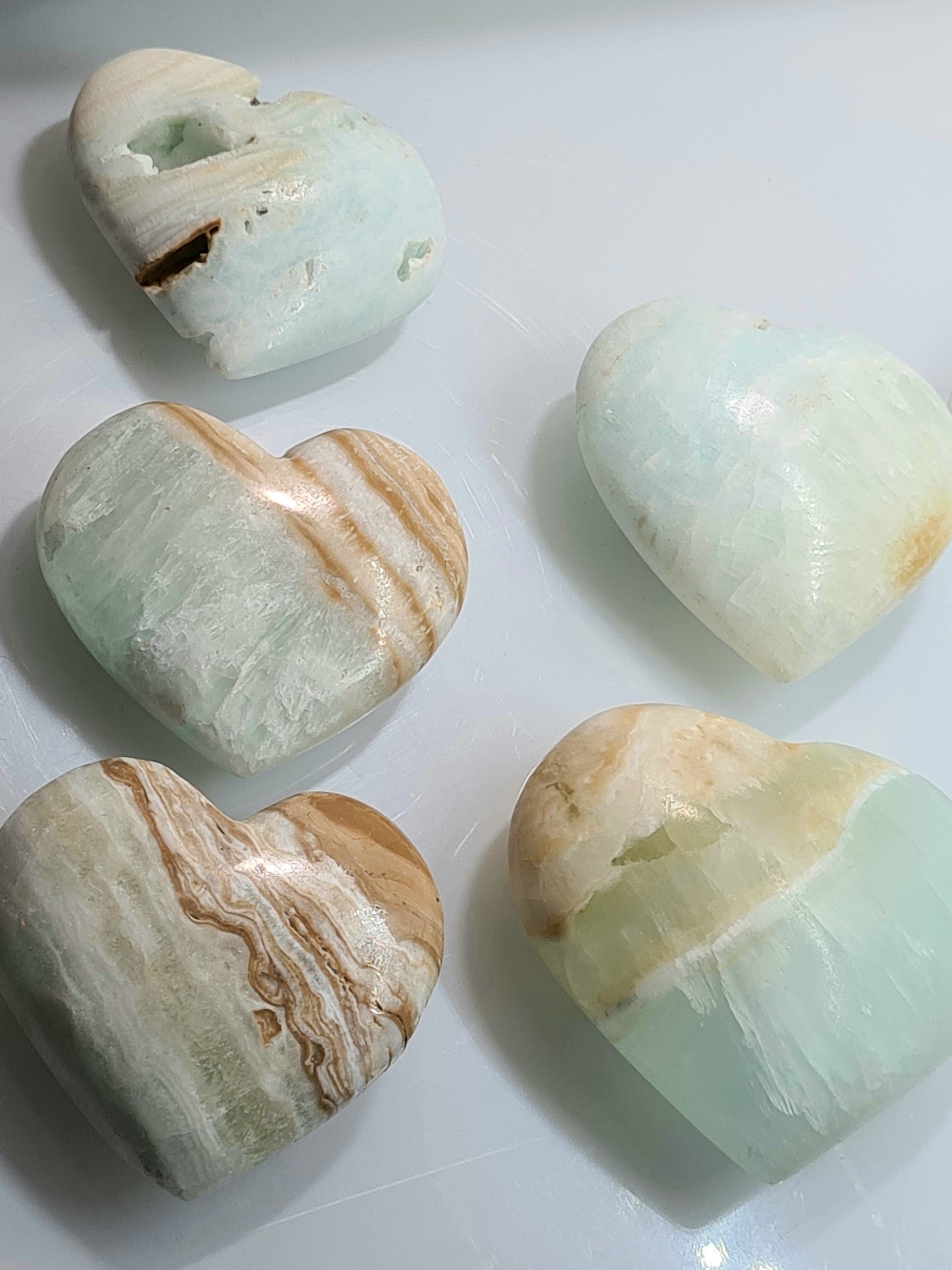 A collection of Caribbean Calcite Heart shaped crystals with blue calcite and brown and white aragonite