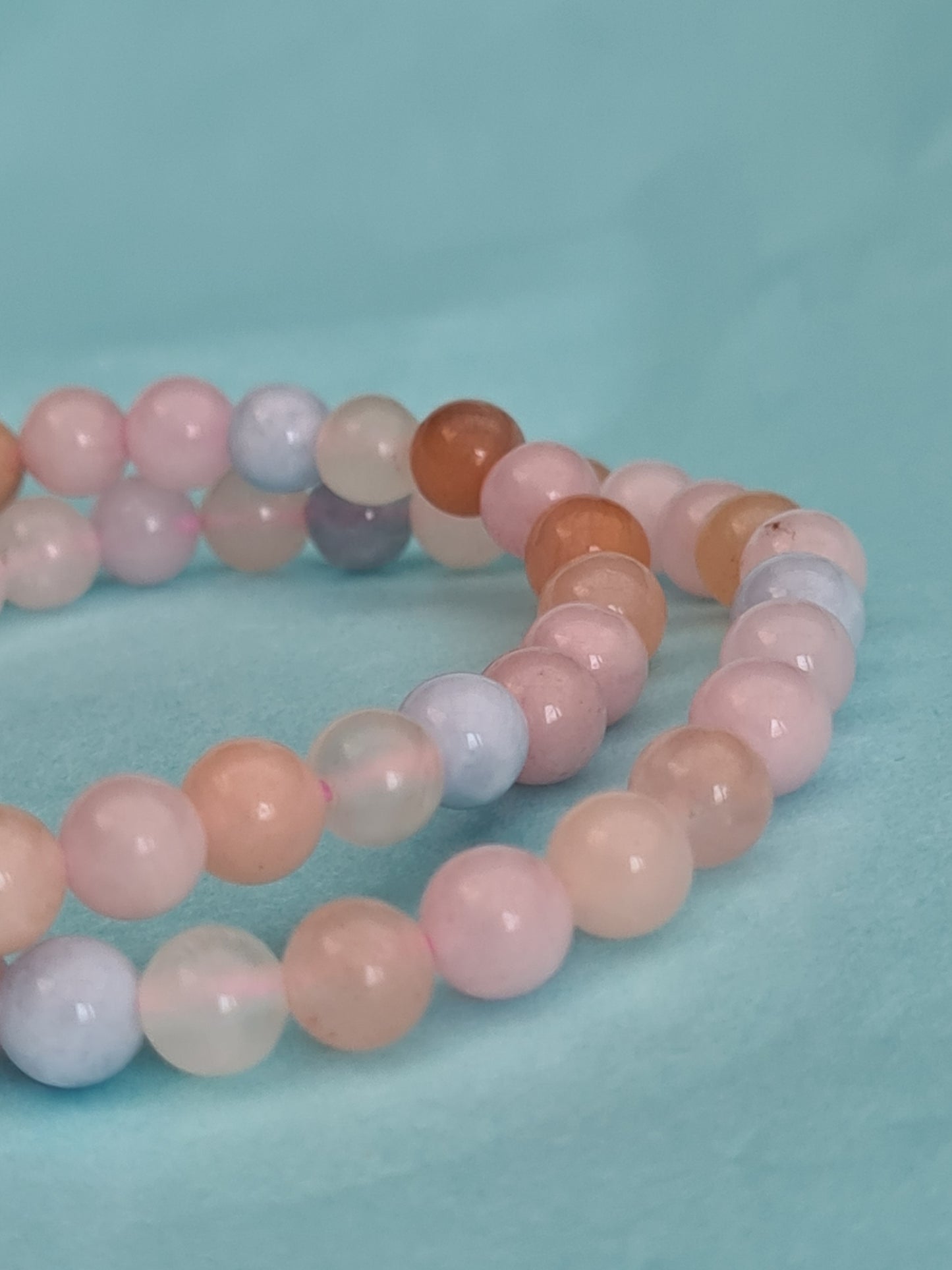 Two 6mm Beaded Morganite Bracelets made up of peach and pink Morganite and Blue Aquamarine Beryl