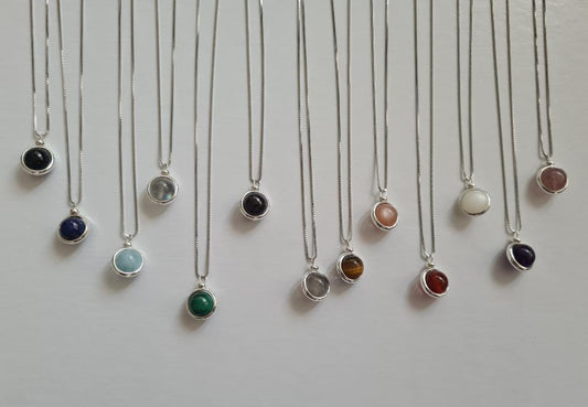 Full Set of the Earth Turns sterping Silver Crystal Necklace Collection, Showing each different colour hanging in a row