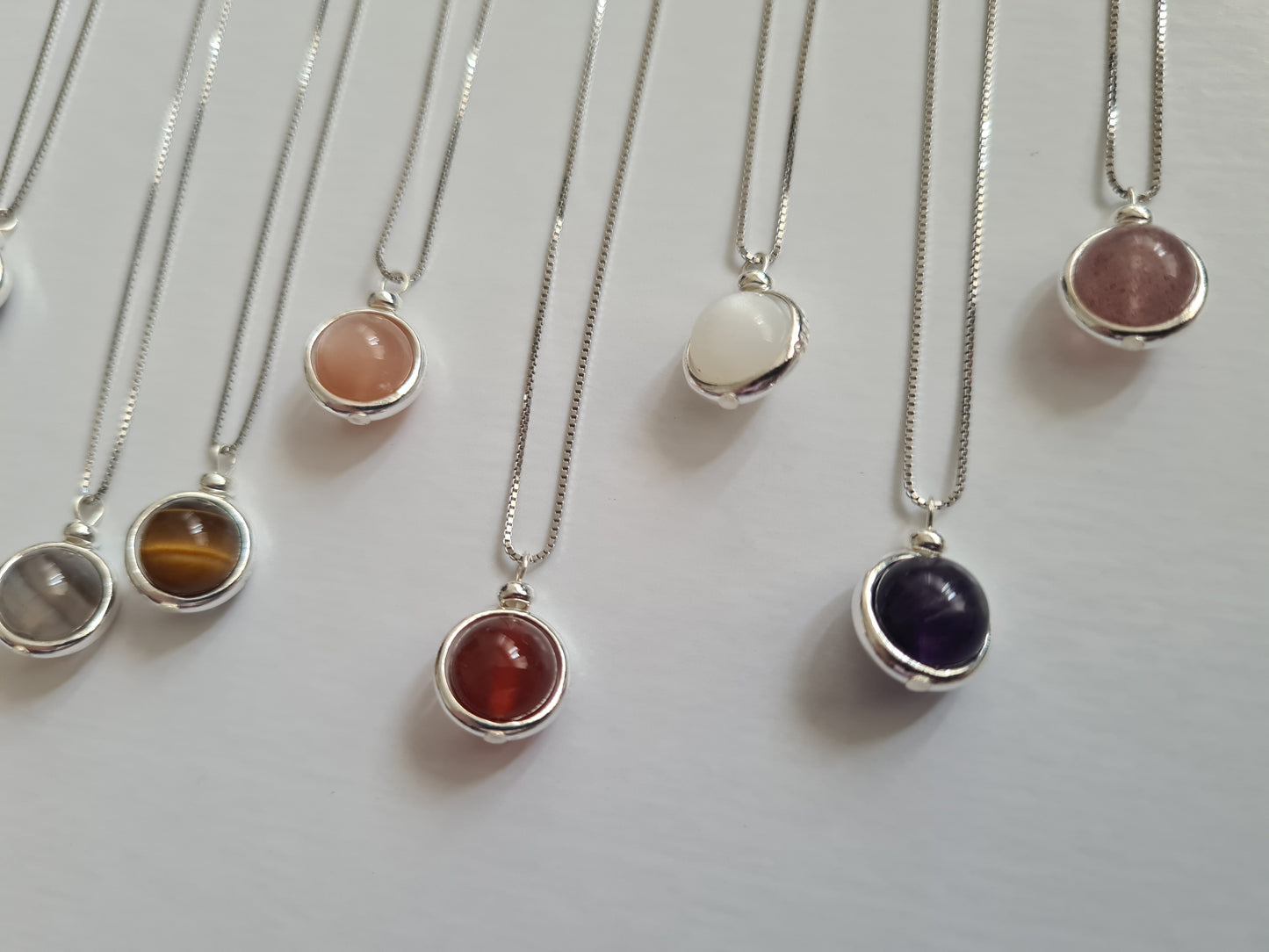 The Earth Turns Sterling Silver Necklace Collection showing the Warm Coloured Crystals