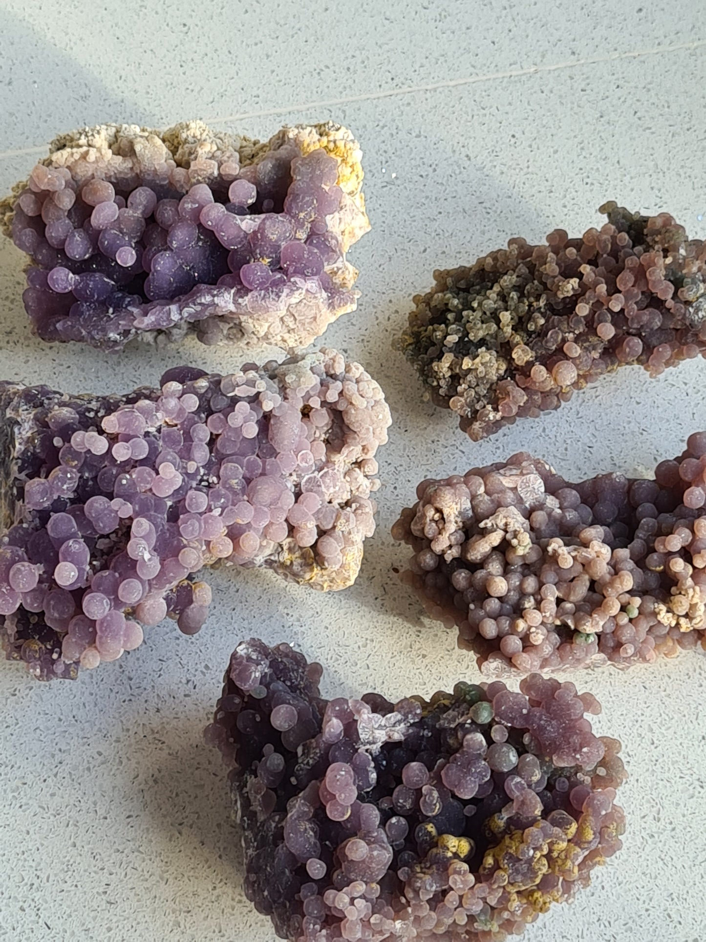 A collection of raw grape agate/chalcedony specimens. Bringing calming energy with clarity and guidance.