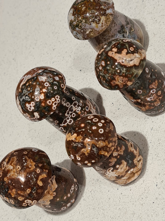 Collection of OJ (Orbicular Jasper) mushroom carvings in colours of red, black, white and yellow with distinct orb patterns. Approx 5cm tall.