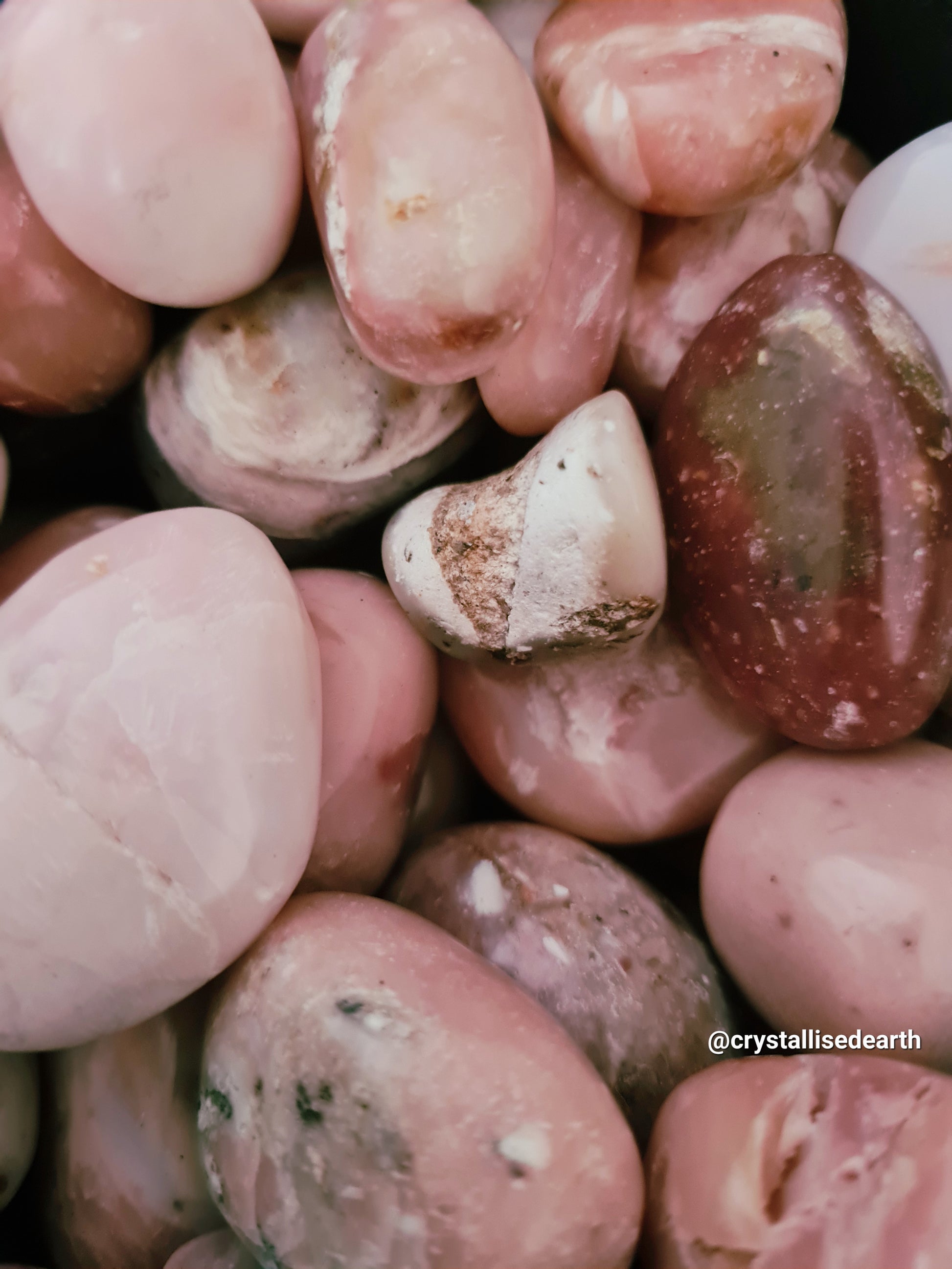 Mixed Pink Opal Tumblestones in shades from light, baby pink to darker Rose Pinks, with natural inclusions and surfaces.