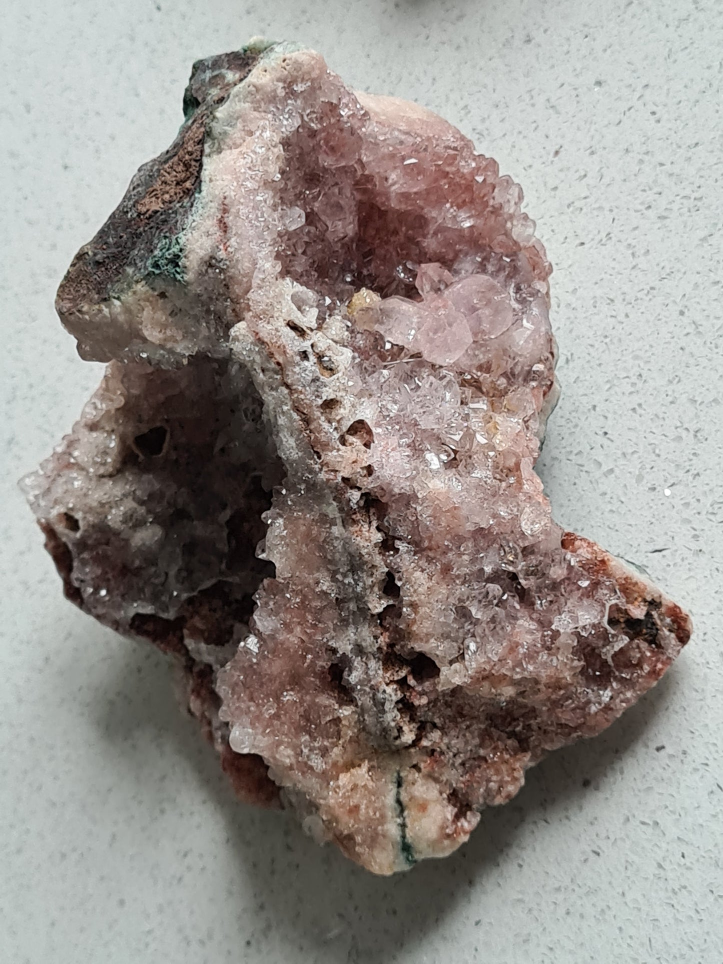 A large, chunky pink amethyst raw cluster with multiple druzy caves