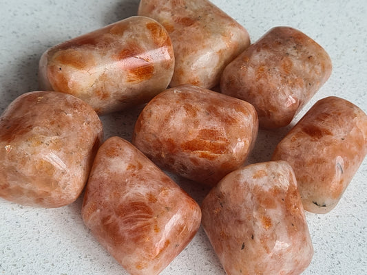 Golden Sunstone Tumbles from India approx 20-30g each, orange in colour with white zones.