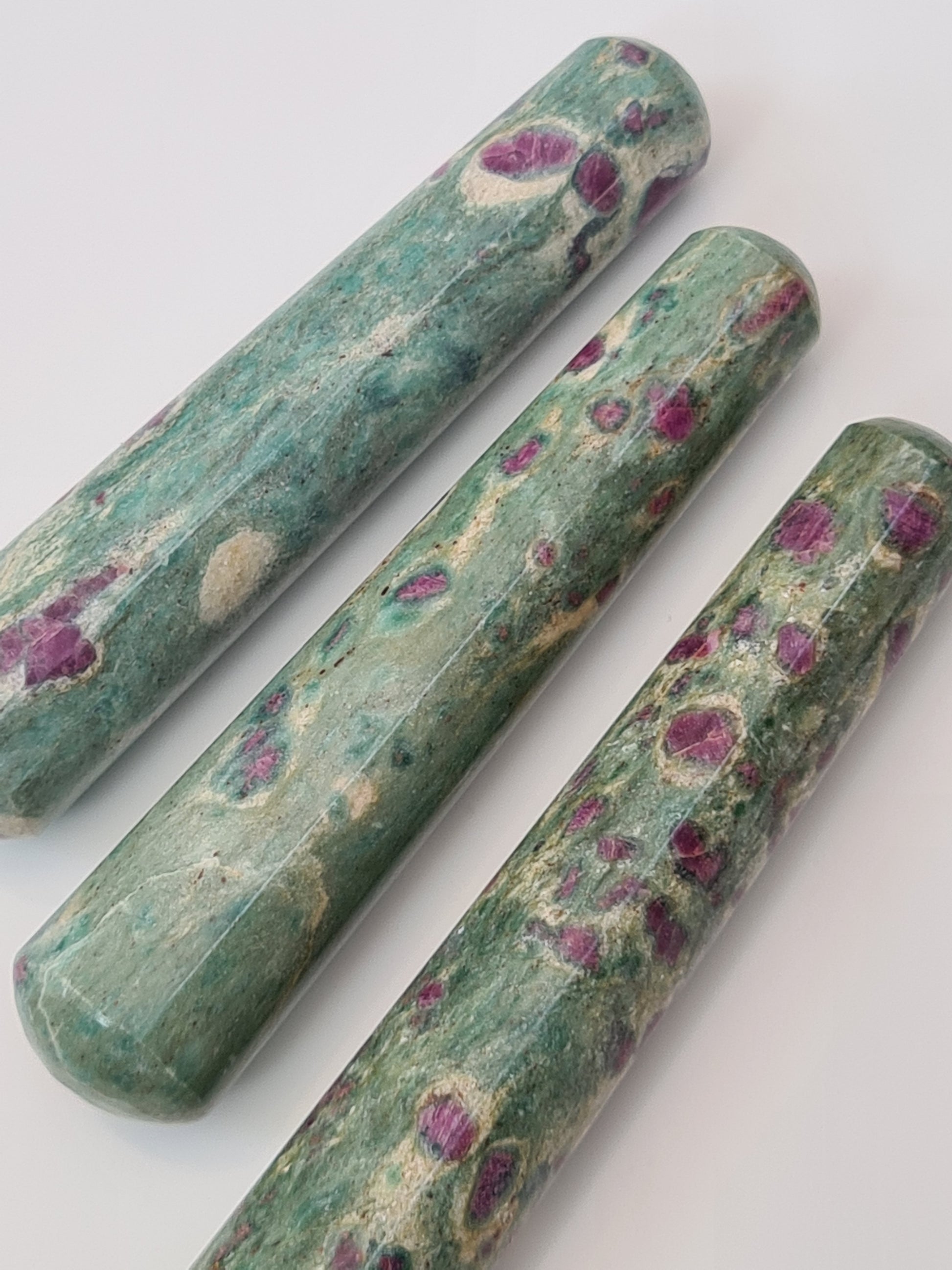 Natural Ruby in Fuchsite Crystal Wands with smooth terminations. 
Photographed on a white background. 