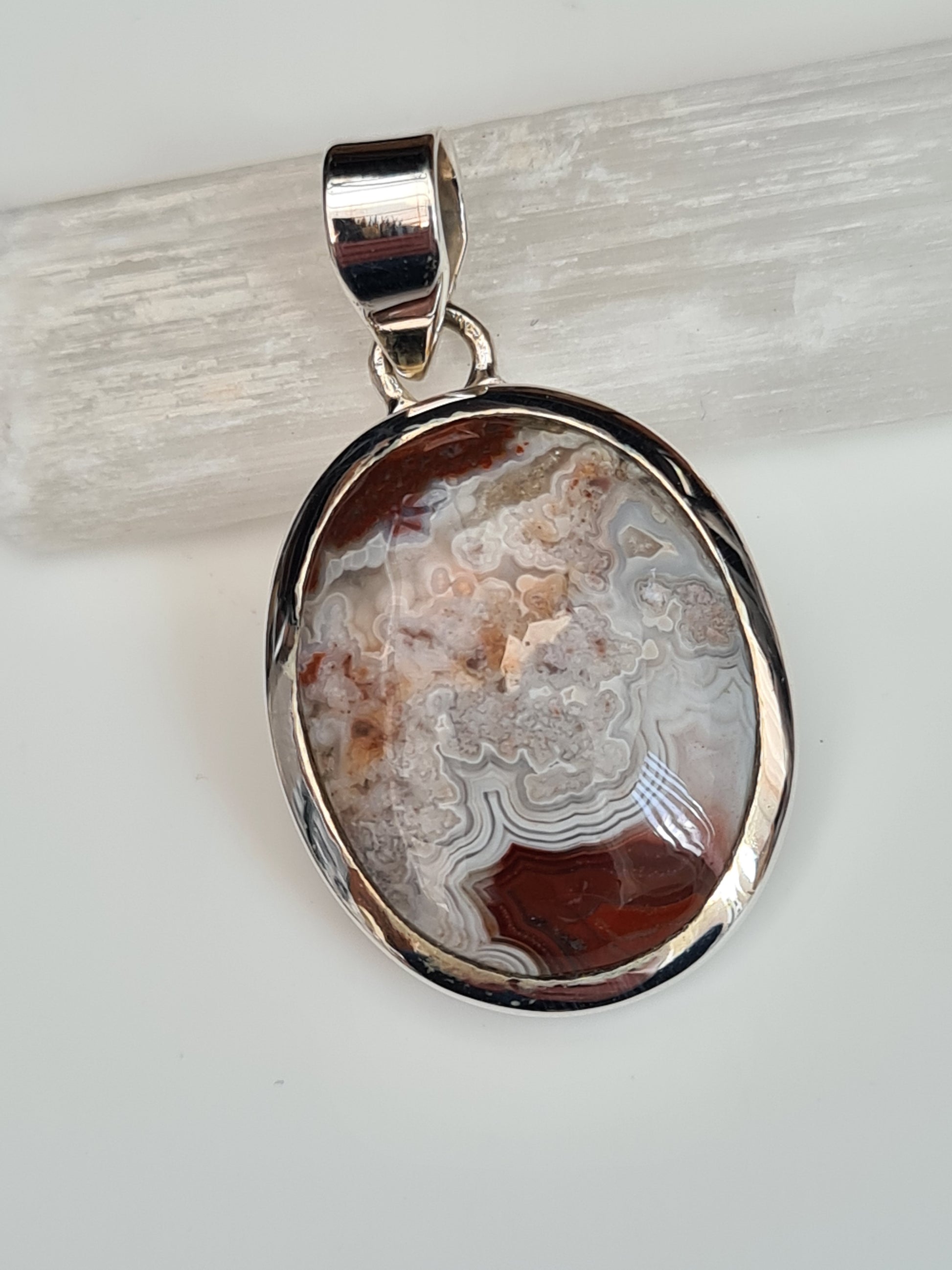 Crazy Lace Agate Pendant in Sterling Silver, the oval shaped agate in colours of white, grey and red. 925 sterling silver