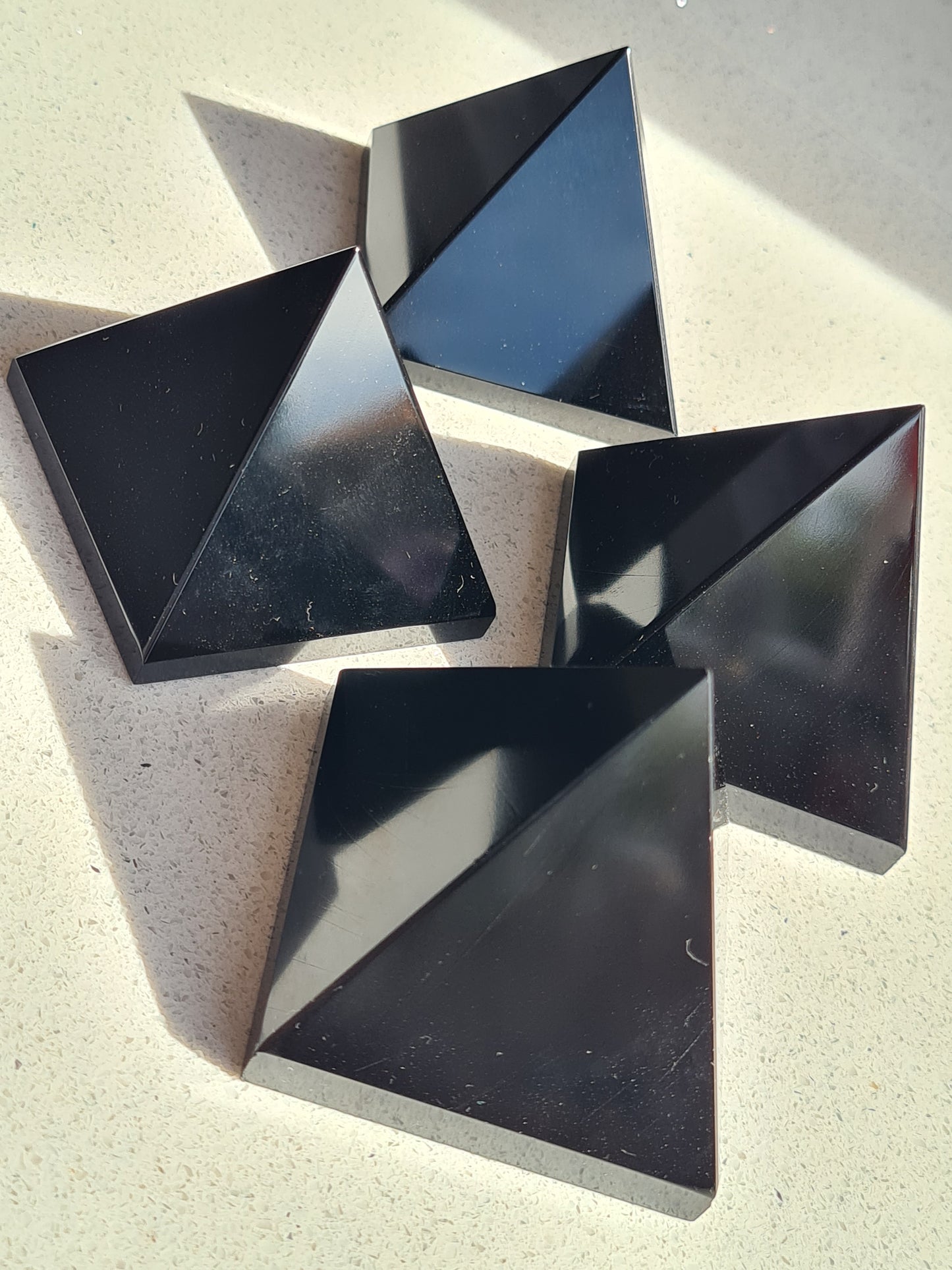 Polished Black Obsidian Pyramids with vitreous lustre and bringing protection and grounding.
