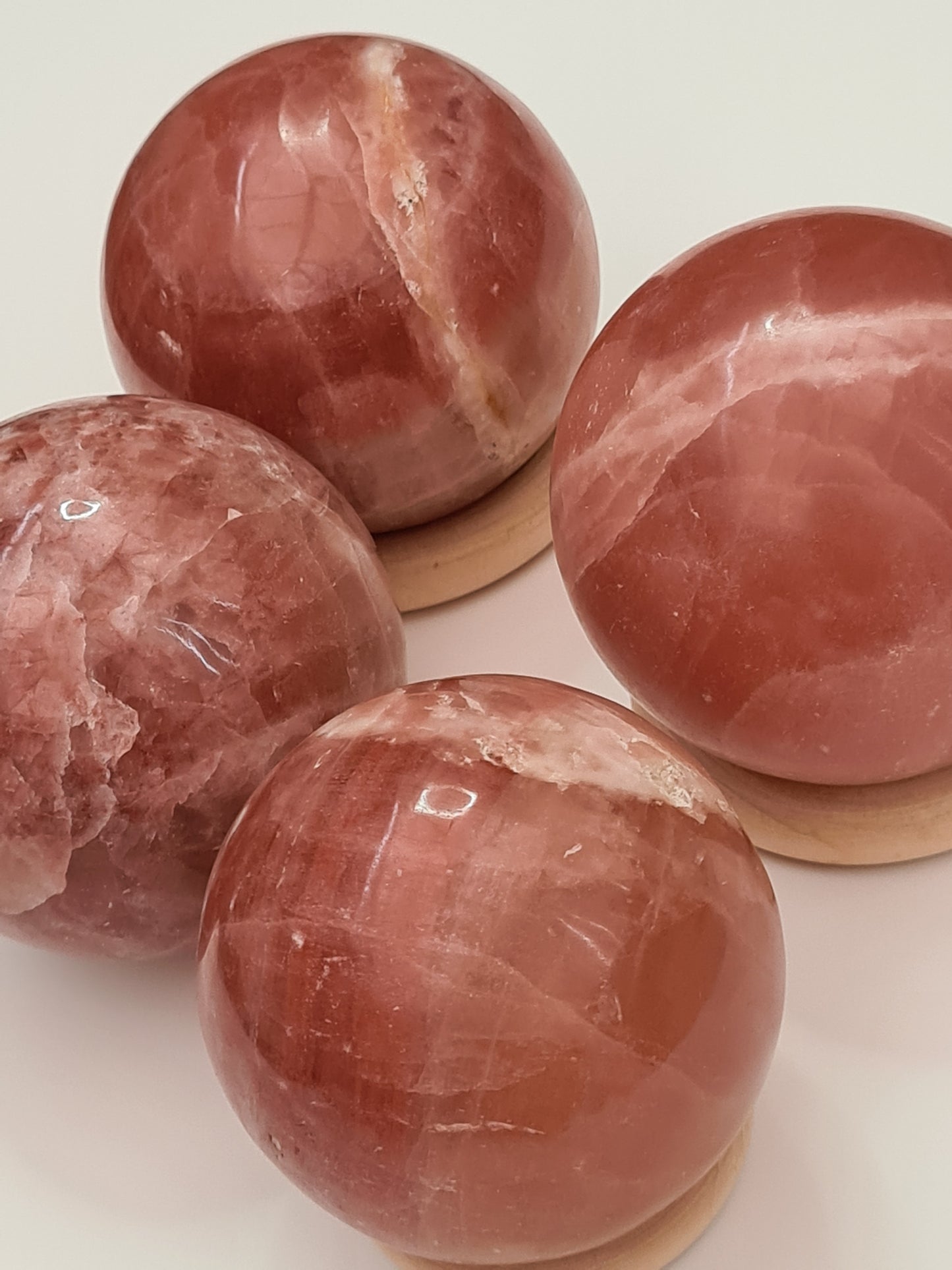 Set of four Beautiful, Bright Rose Calcite Soheres displaying banding and white zoning
