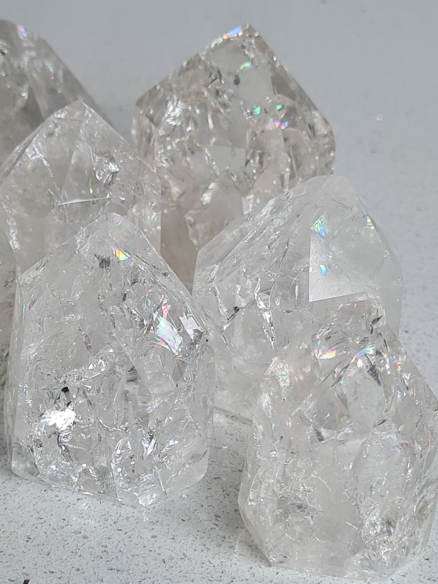 Close up of our Brazilian Fire and Ice Quartz Points, showing pure clarity and rainbows found in each point