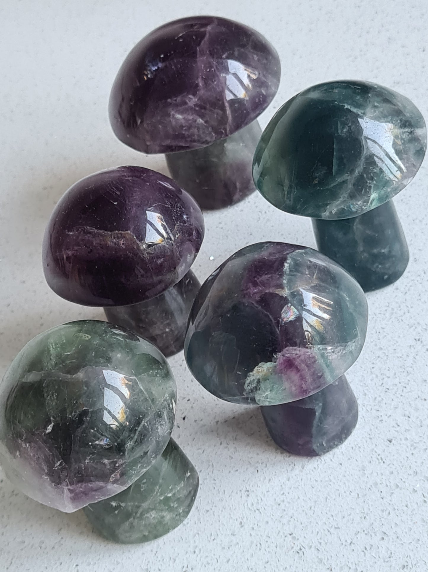 Rainbow Fluorite Mushroom Carving in colours of green, purple with some blue banding.