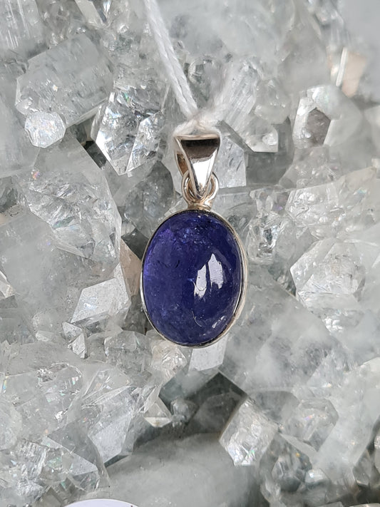 Natural Deep Purple Tanzanite Oval Cabochon set into Sterling Silver with an articulating bail.