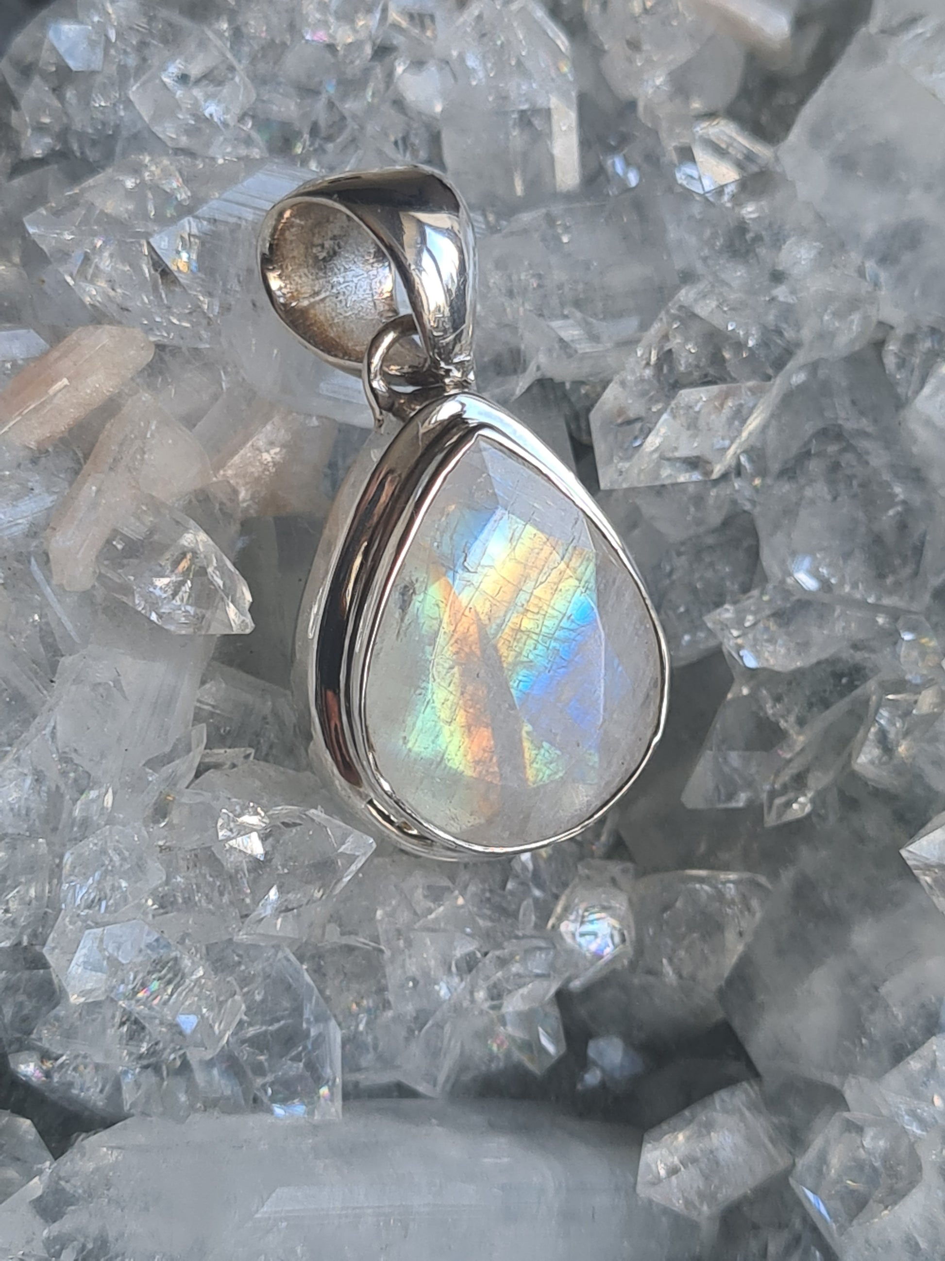 A vivid Rainbow Moonstone Teardrop shaped pendant in sterling silver. Bright rainbow flash!!