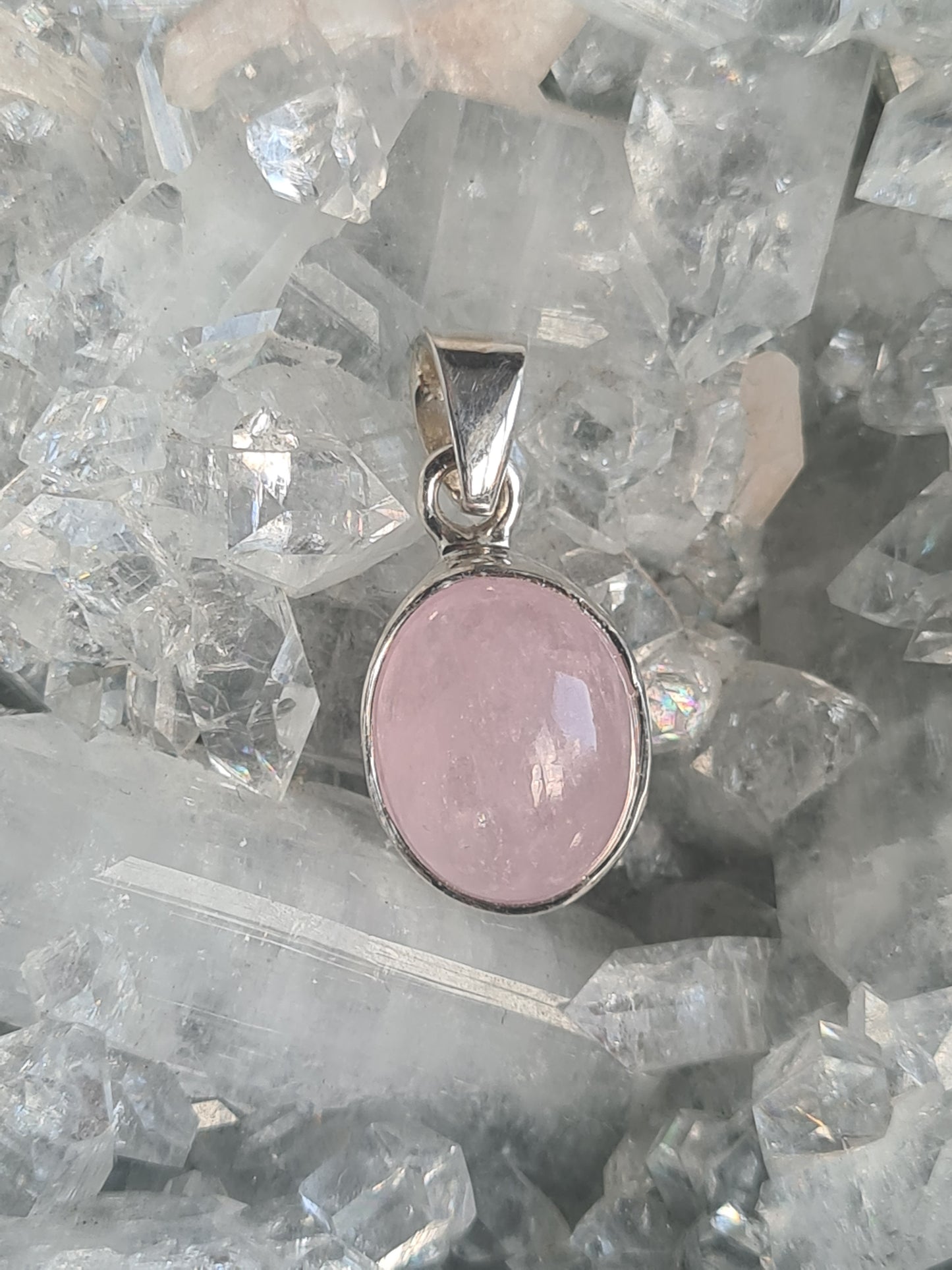 A single stone Pink Morganite pendant in sterling silver. 25mm length, oval shape