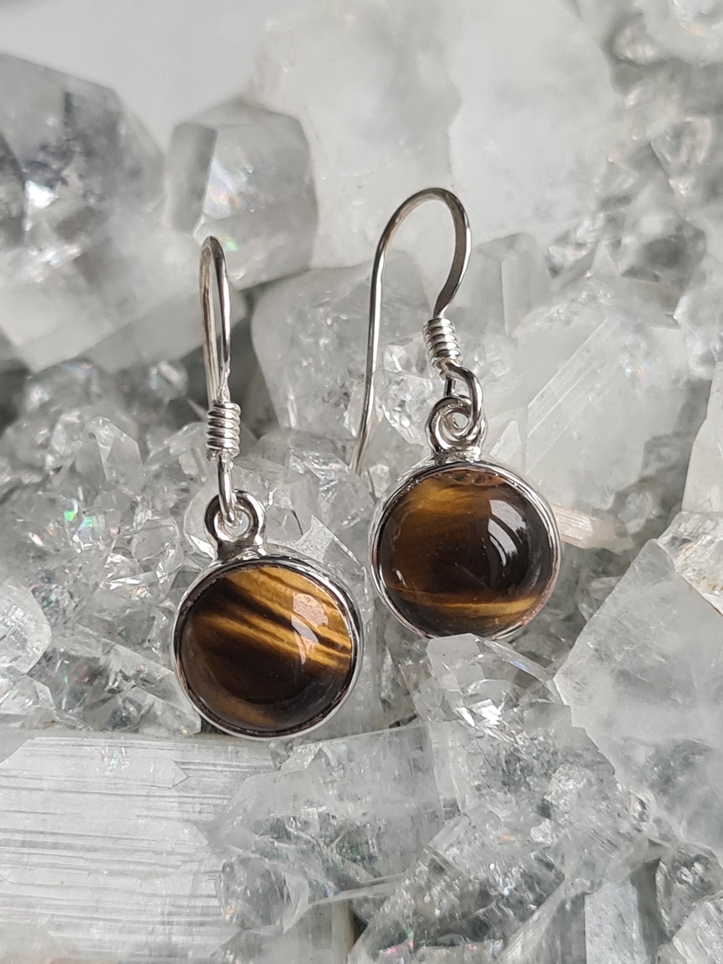 A pair of round cabochon golden tigers eye set drop earrings in sterling silver