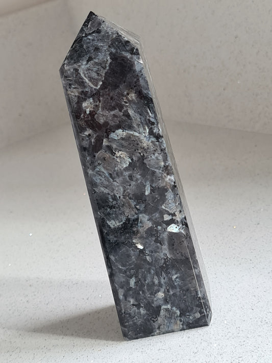 Silver flash Larvikite obelisk from Norway. Black bodycolour, bright silvery flashes, for protection and clarity.