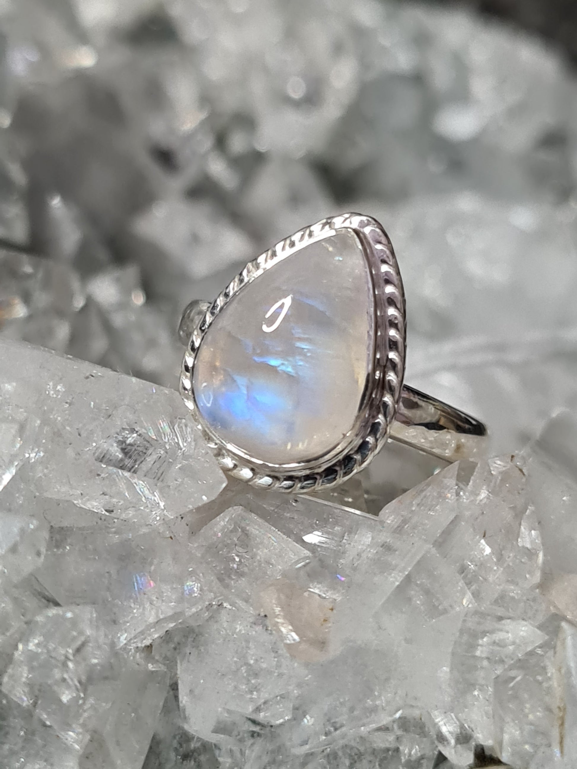 A rainbow moonstone ring, pear shaped with twisted rope silver frame in Sterling Silver. UK  size L