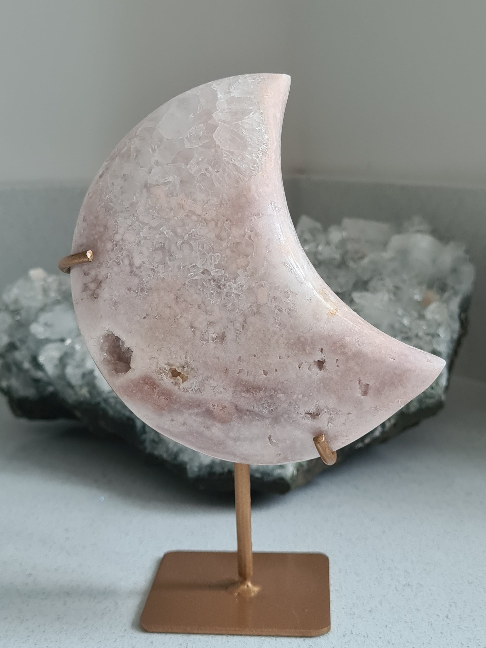 Natural Pink Amethyst Crescent Moon Crystal on Stand. Light to bubblegum pink colours with clear quartz caves.