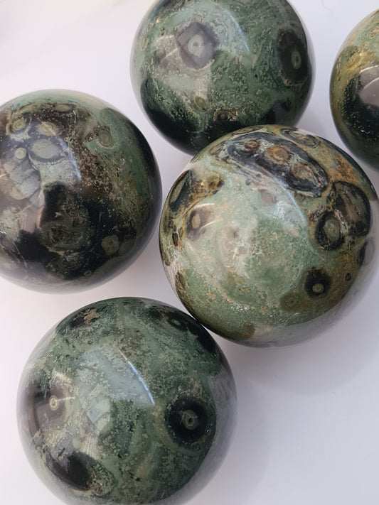 Natural Kambaba Jasper Spheres, showing green stone with orbicular patterns in grey and black.