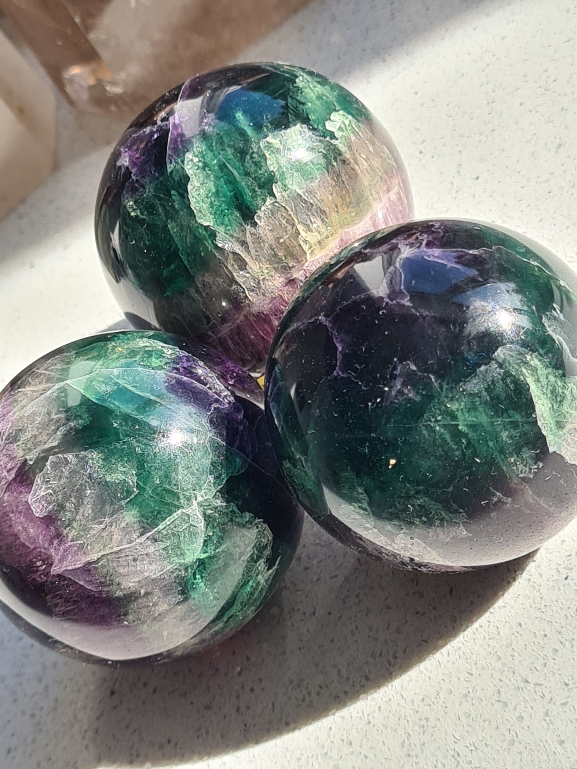 Three Deep Green and Purple Banded Fluorite Spheres