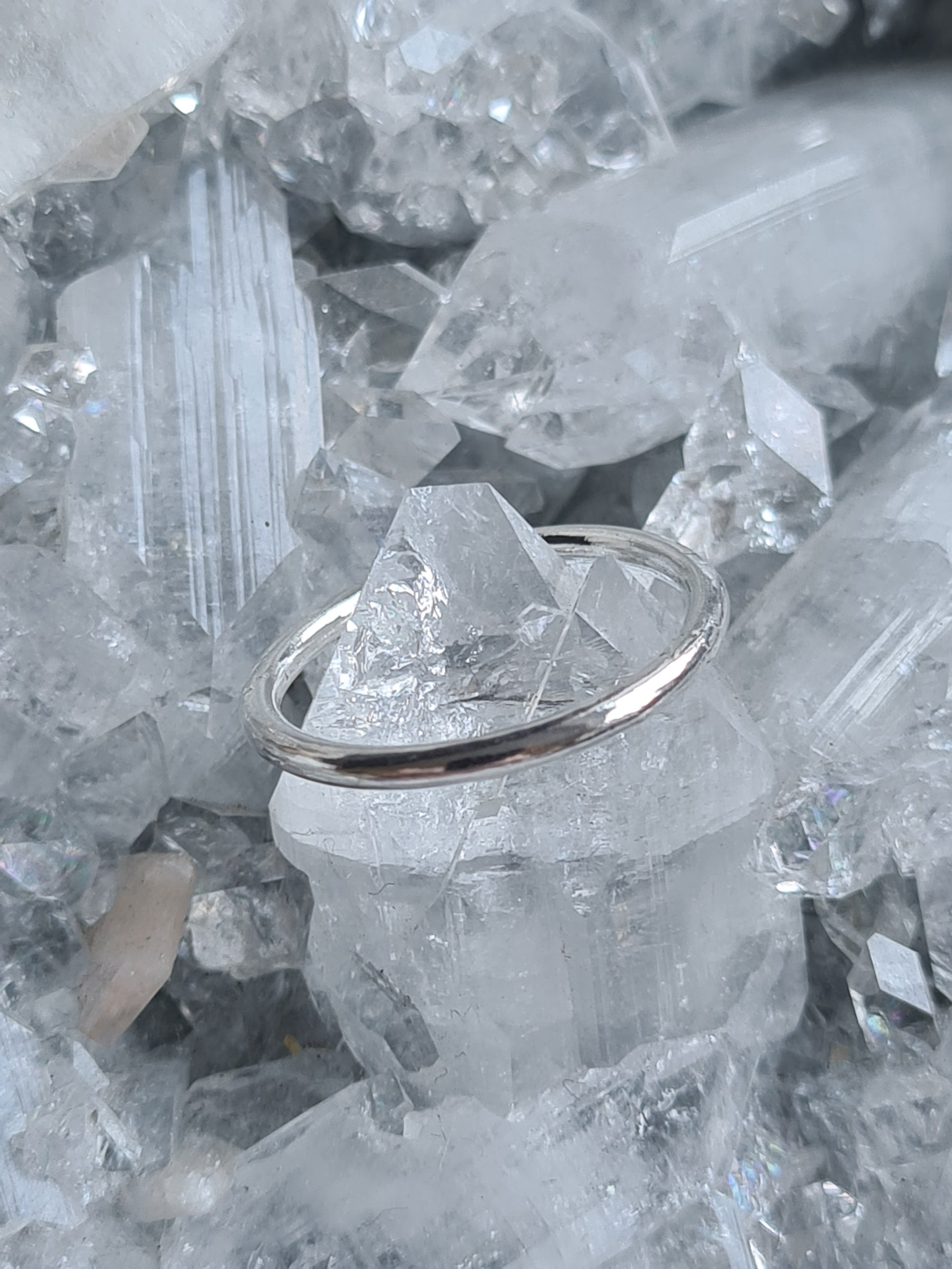Plain sterling silver band ring approx. 2mm wide. Stackable with other rings. Shown on an apophyllite crystal.